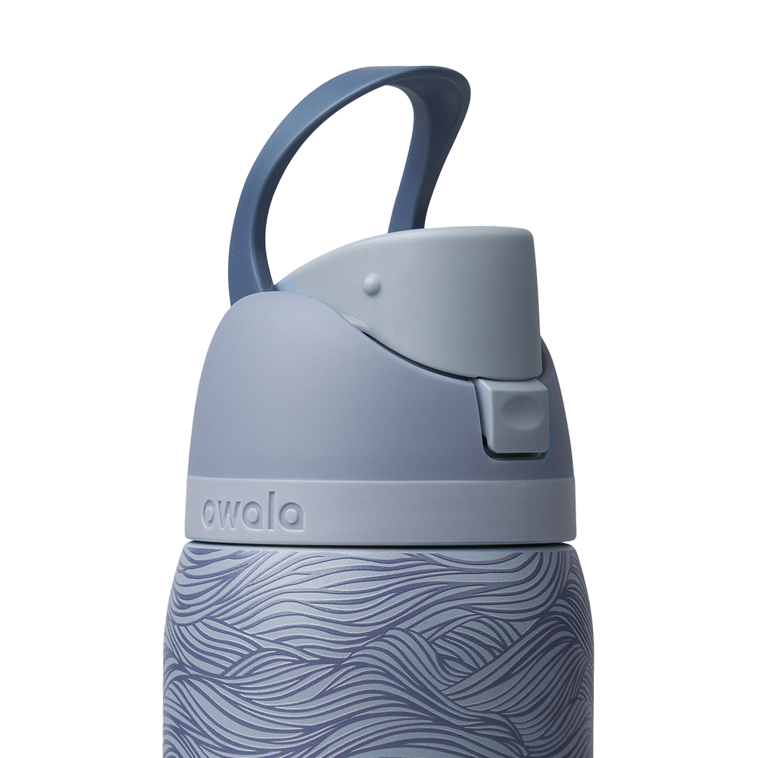 Owala FreeSip 32oz, slate blue body with embossed wave texture, lighter blue-gray lid with darker blue carry loop raised
